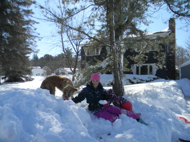 Hemi and girls in the snow in front of the house